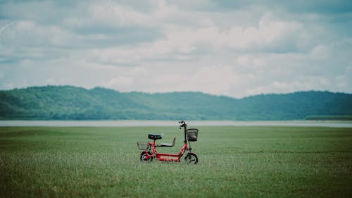 Free Red Bicycle in the Meadow  Stock Photo