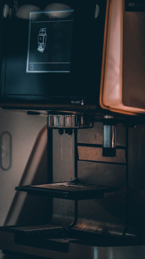 Free A stylish coffee machine in a café setting, emitting subtle steam and ready to brew. Stock Photo