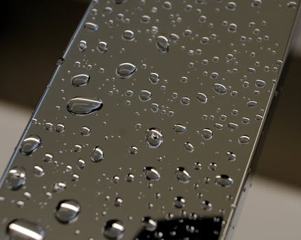 Detailed photo of water droplets on a glass surface, creating a reflective and clean aesthetic.