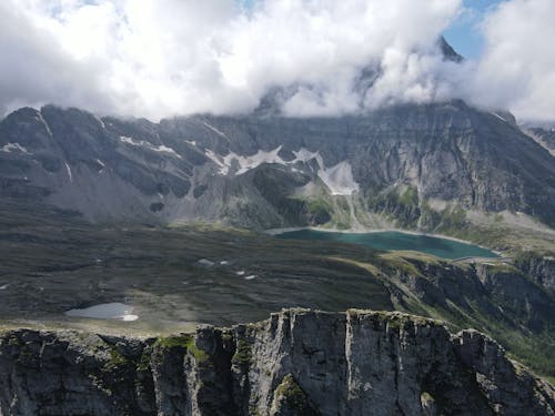 Landscape with Rocky Mountains in Clouds