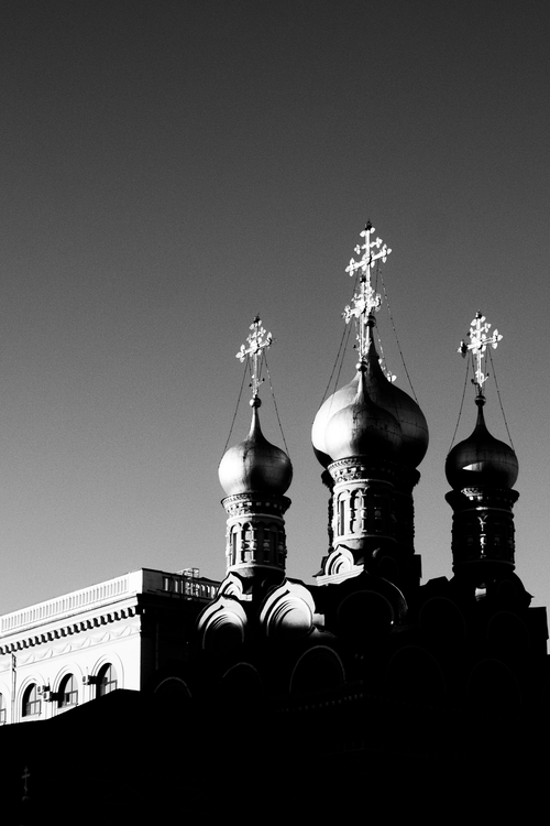 Free Stunning black and white photo of Orthodox church domes against a clear sky, showcasing religious architecture. Stock Photo