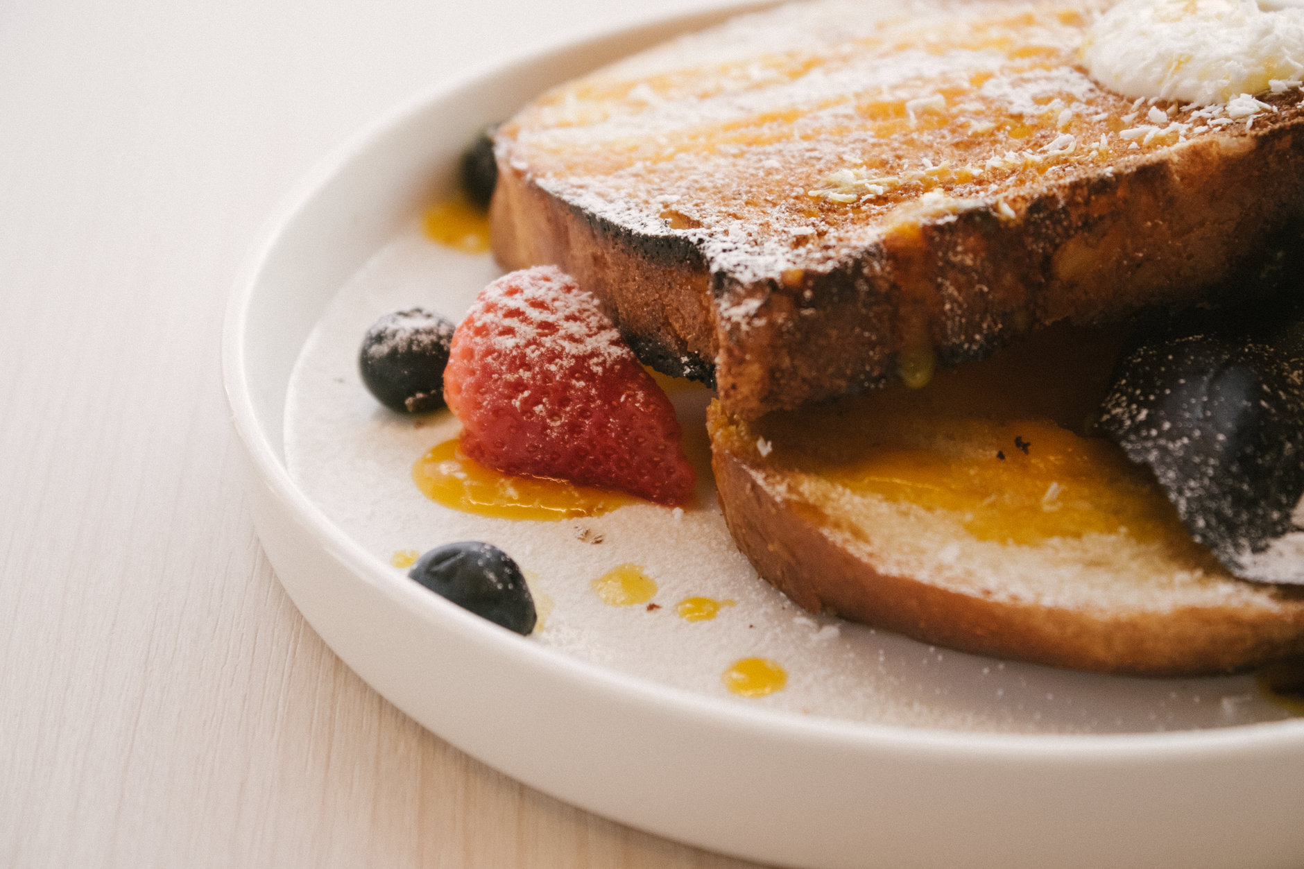 Golden cranberry stuffed French toast sizzling in a pan