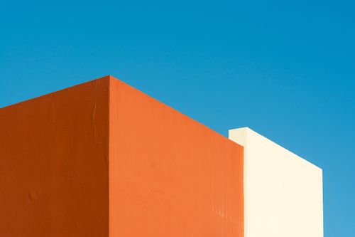Free Abstract view of colorful building walls against a clear blue sky, showcasing minimalist architecture. Stock Photo