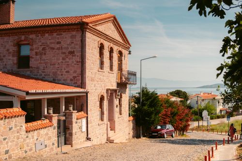 Free Charming historic stone house on cobblestone street in a quaint village near the sea in Balıkesir, Türkiye. Stock Photo