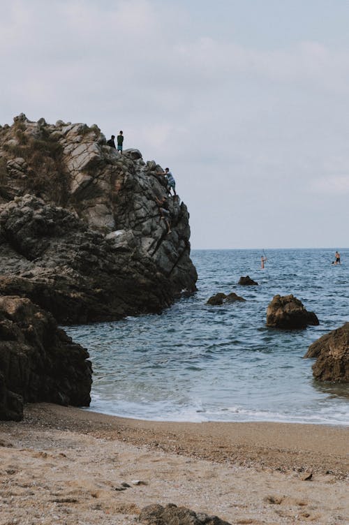 Free Photo of People on Top of a Rock Formation Stock Photo