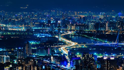 Free A dynamic night view of a modern city with dazzling lights and urban architecture. Stock Photo