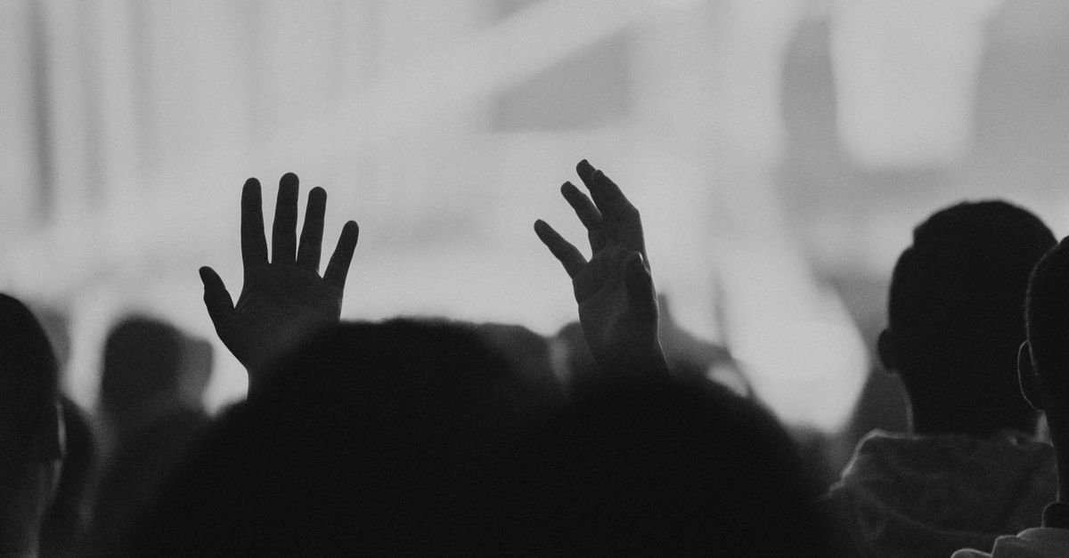 congregation with hands raised during worship in Ho Ghana
