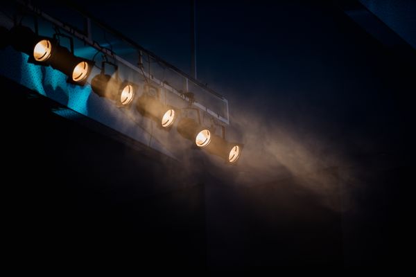 Stage lights cutting through haze — photo by Filipe Braggio on Pexels