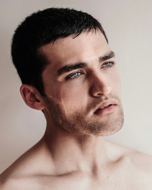 Free Detailed headshot of a young man with blue eyes against a neutral background. Stock Photo