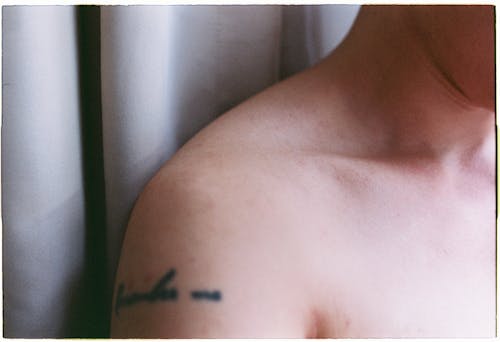 A Person with Tattoo on his Shoulder