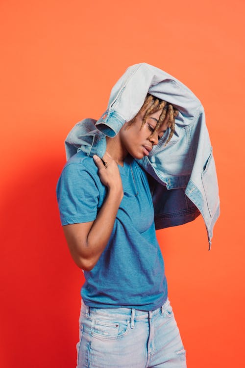 A Person with Dreadlocks Hairstyle with Orange Background