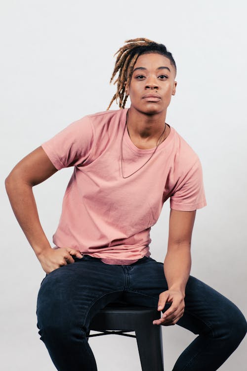 Person in Pink Shirt Sitting on a Black Chair