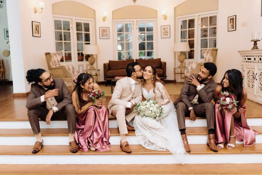 Wedding Couple Sitting With Friends
