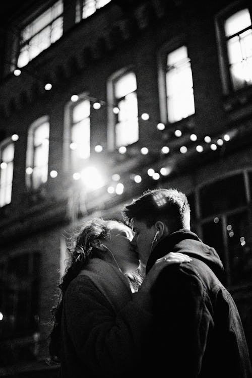 Grayscale Photo of Man and Woman Kissing