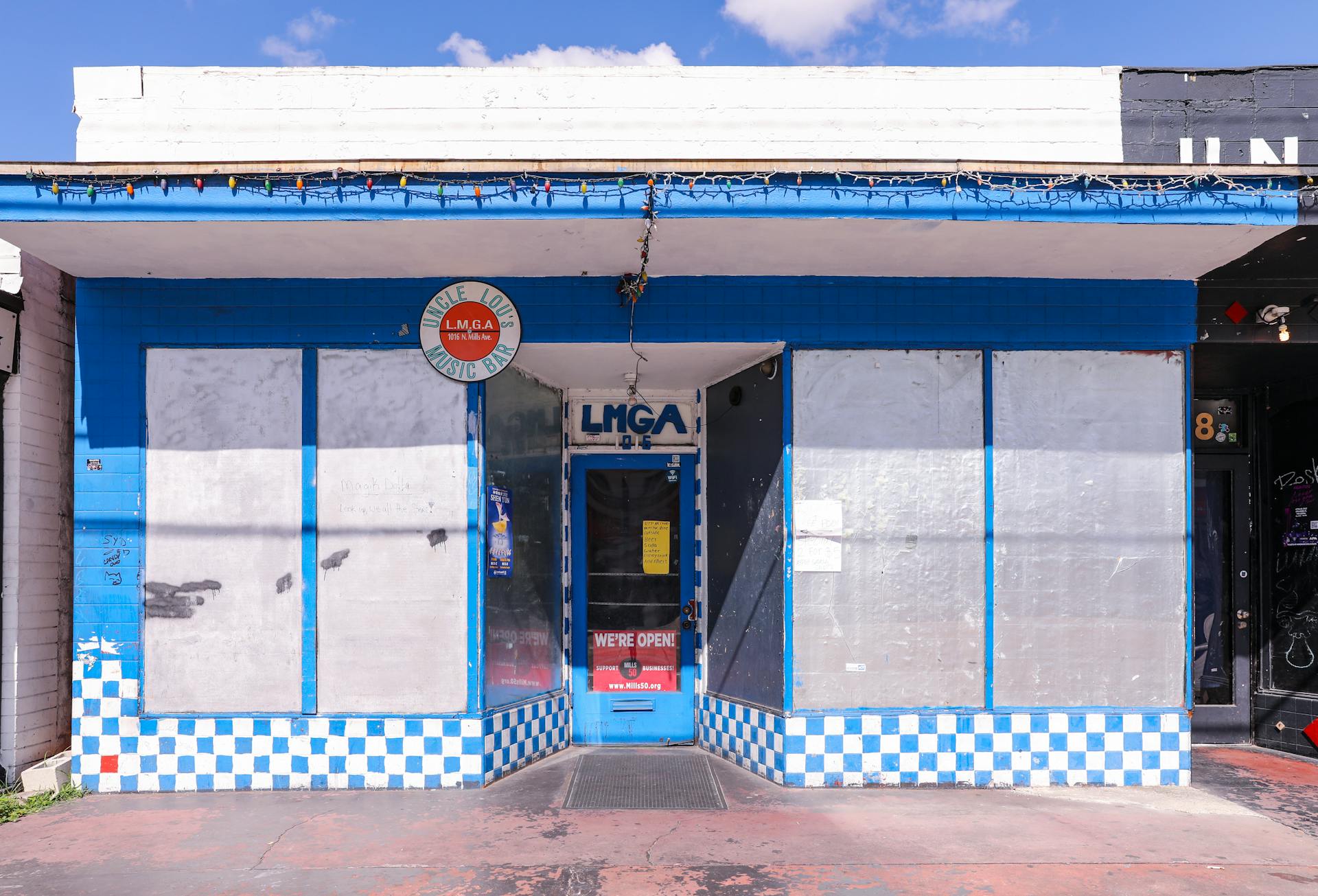 Front view of Uncle Lou's Music Bar, Orlando - vibrant blue exterior with signage.