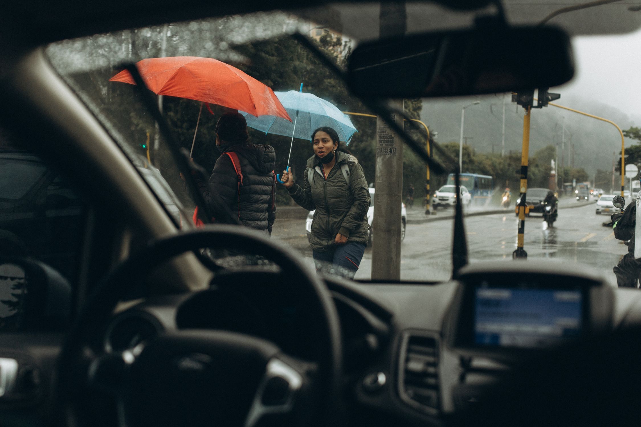 People on the Road Holding Umbrellas on a Rainy Day · Free Stock Photo
