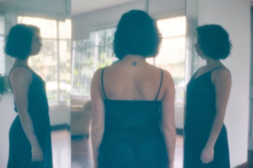 Reflections of a Woman in a Black Dress