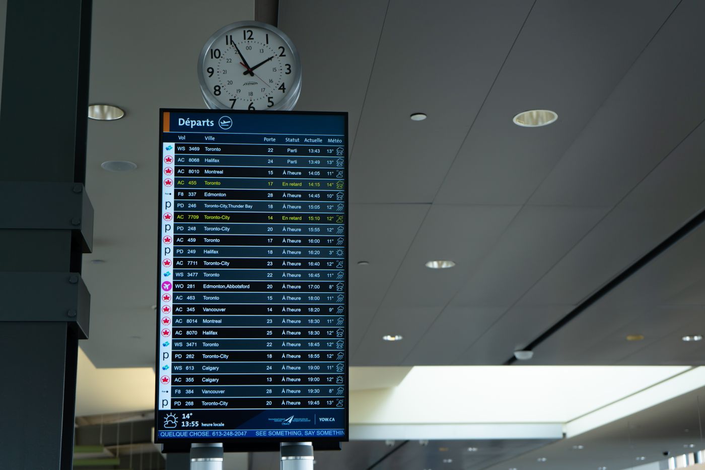 A departures information board showing flight schedules in an airport terminal