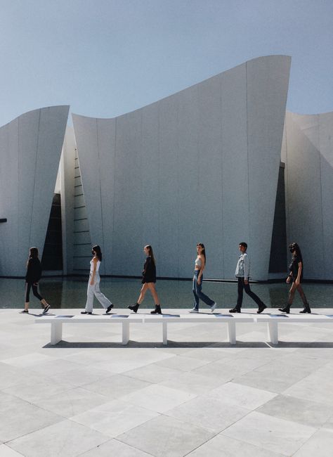 Group of people walking near contemporary architectural landmark in Puebla, Mexico.
