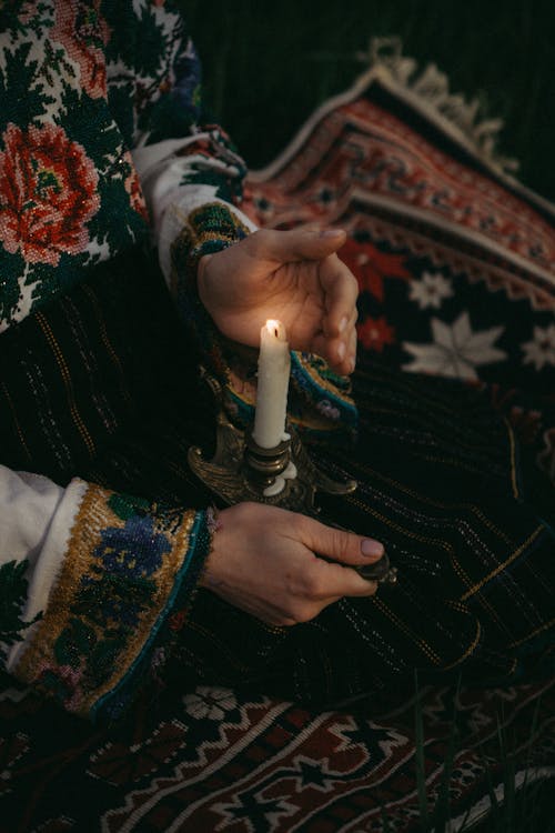 Hands Holding a Lit Candle