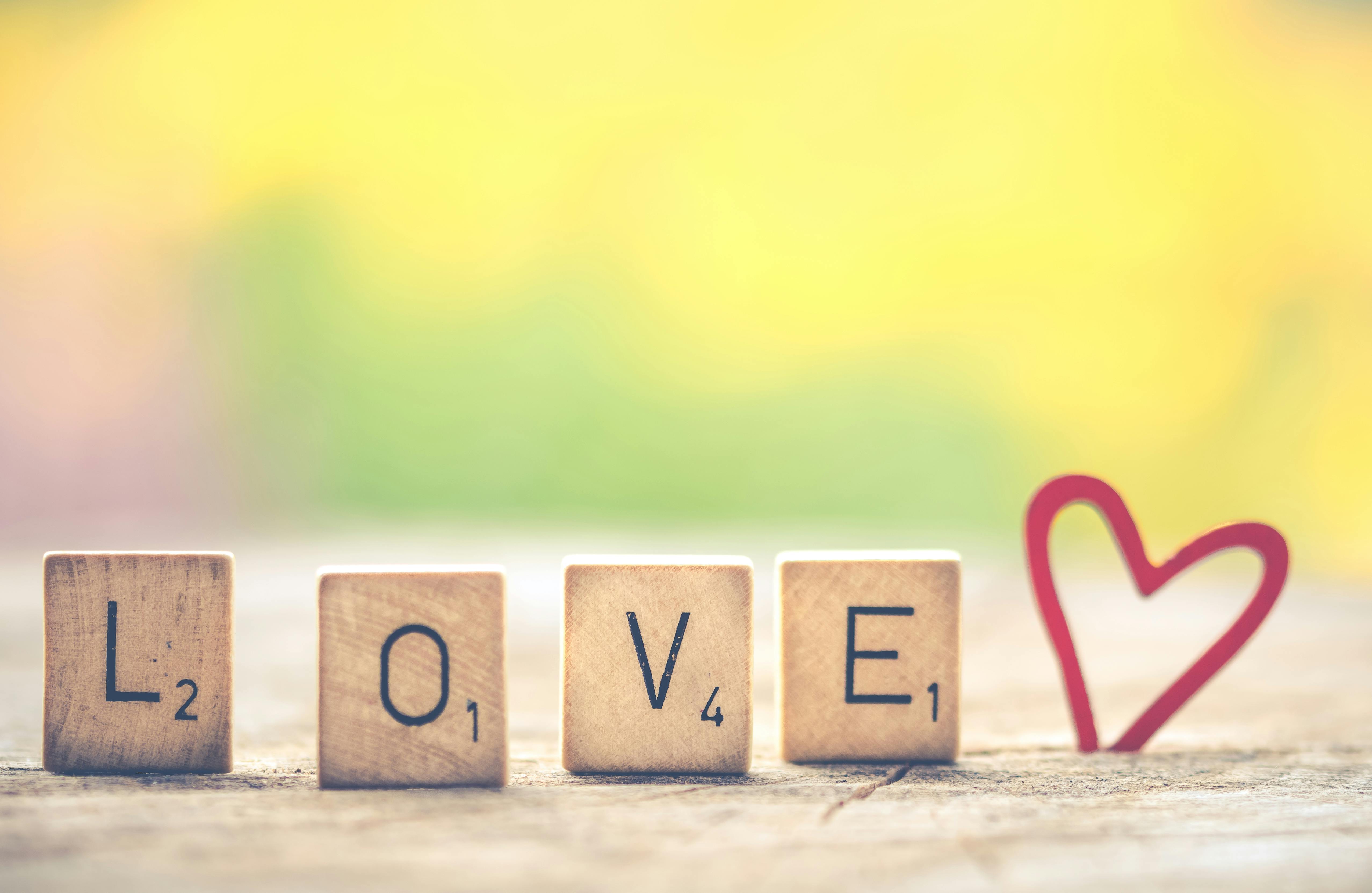 photo of scrabble letter tiles forming the word love