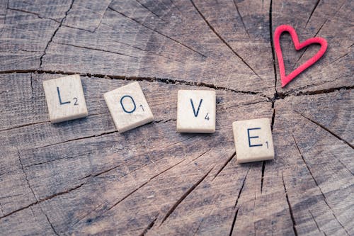 Photo of Scrabble Letter Tiles Forming the Word Love.