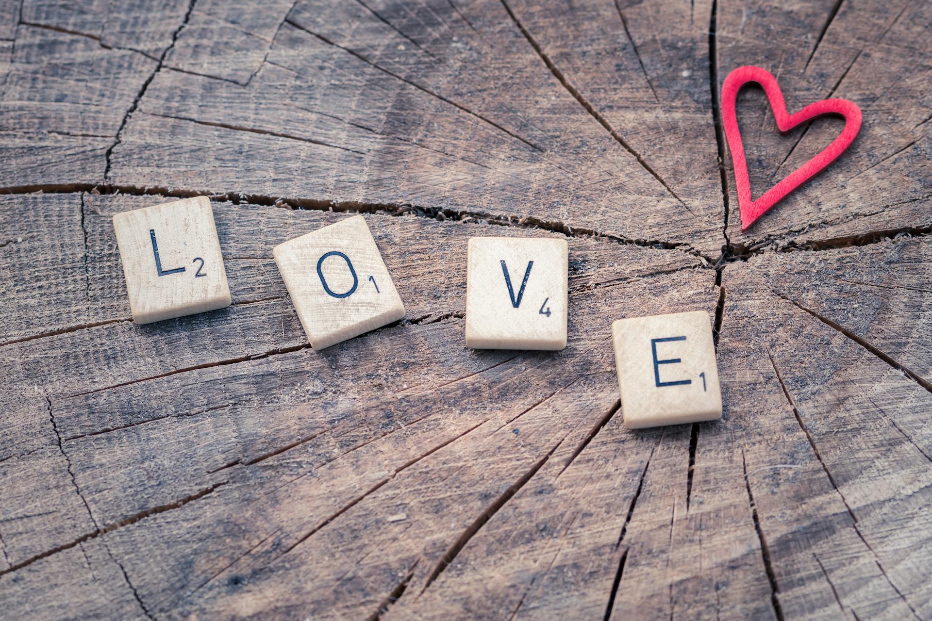 Photo of Scrabble Letter Tiles Forming the Word Love.