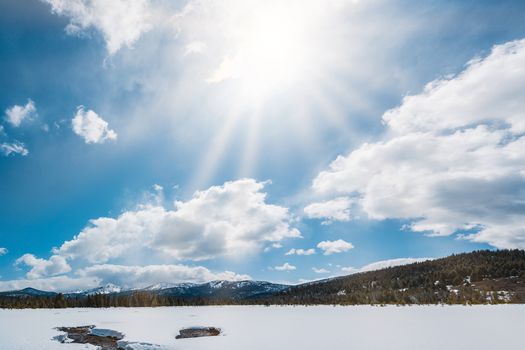 A breathtaking winter landscape showing snow-covered mountains and a bright blue sky in Stanley, Idaho.