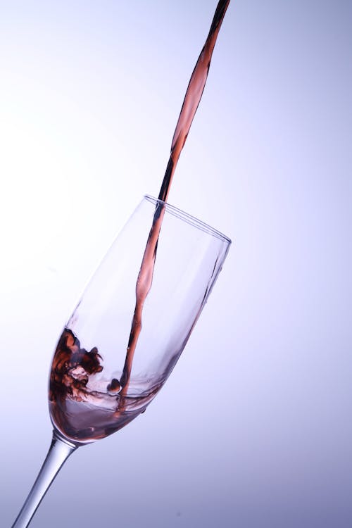 Pouring Wine on Clear Glass 