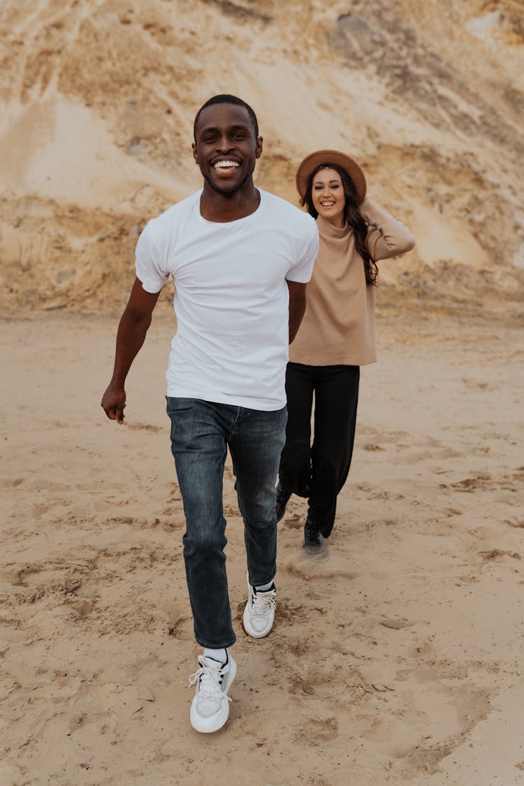 Couple Walking Together On Sand