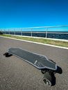 Black Skateboard on Gray Concrete Road
