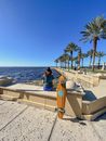 Back View of a Person Sitting on the Seawall