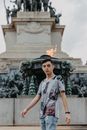 Man in Grey Crew Neck T-shirt Standing Near Grey Concrete Building