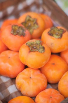 A vibrant close-up of fresh persimmons showcasing their natural sweetness and vibrant color.