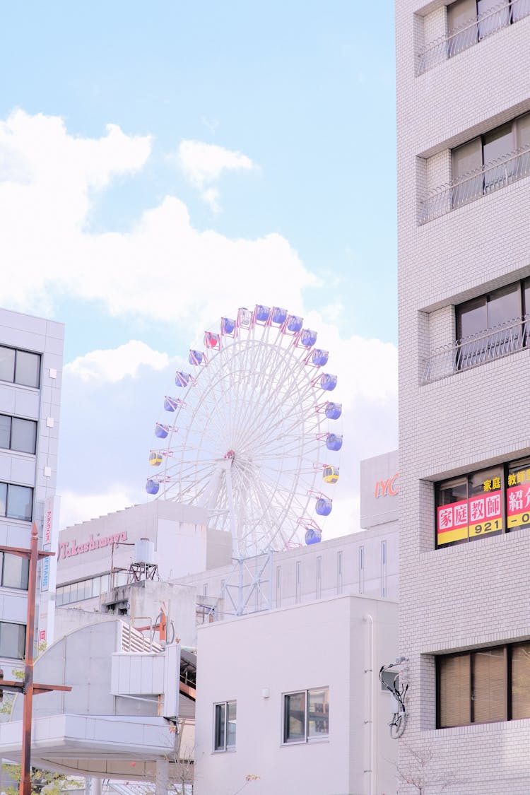 Ferris Wheel Near White Buildings