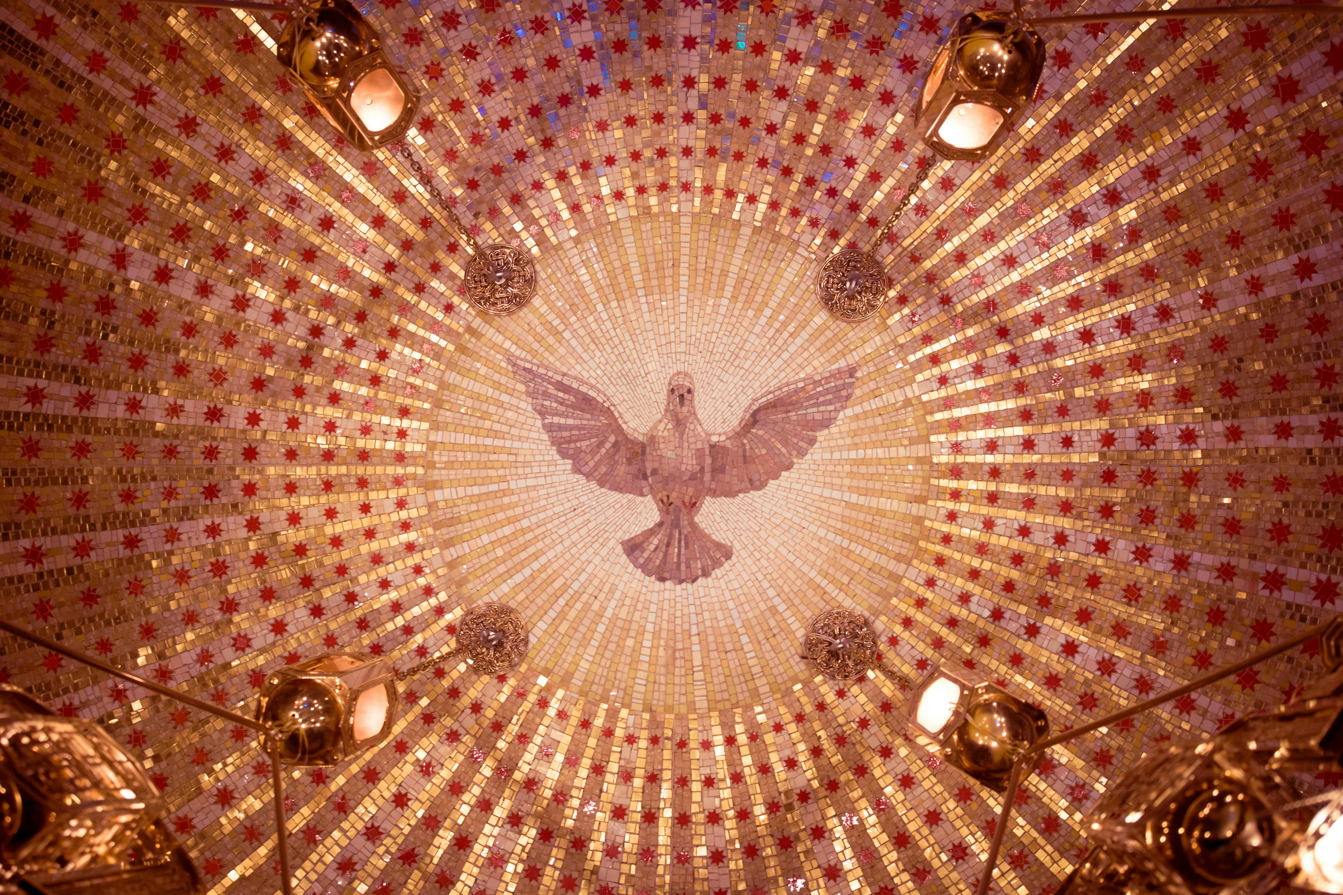 Free Intricate dome mosaic featuring a central dove design with gold and red patterns. Stock Photo