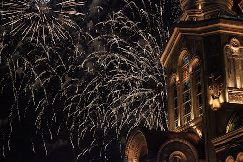 Photo of Church Tower with Fireworks Display 