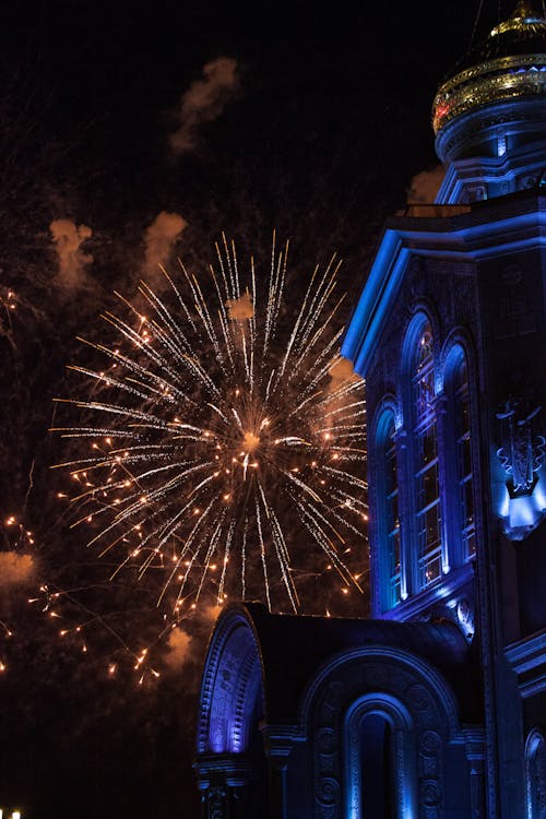 Church Tower With Fireworks Display on Sky during Night Time