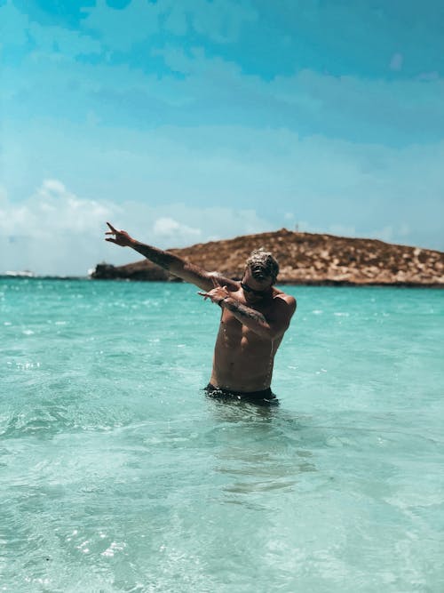 Free Man Swimming in Sea Stock Photo