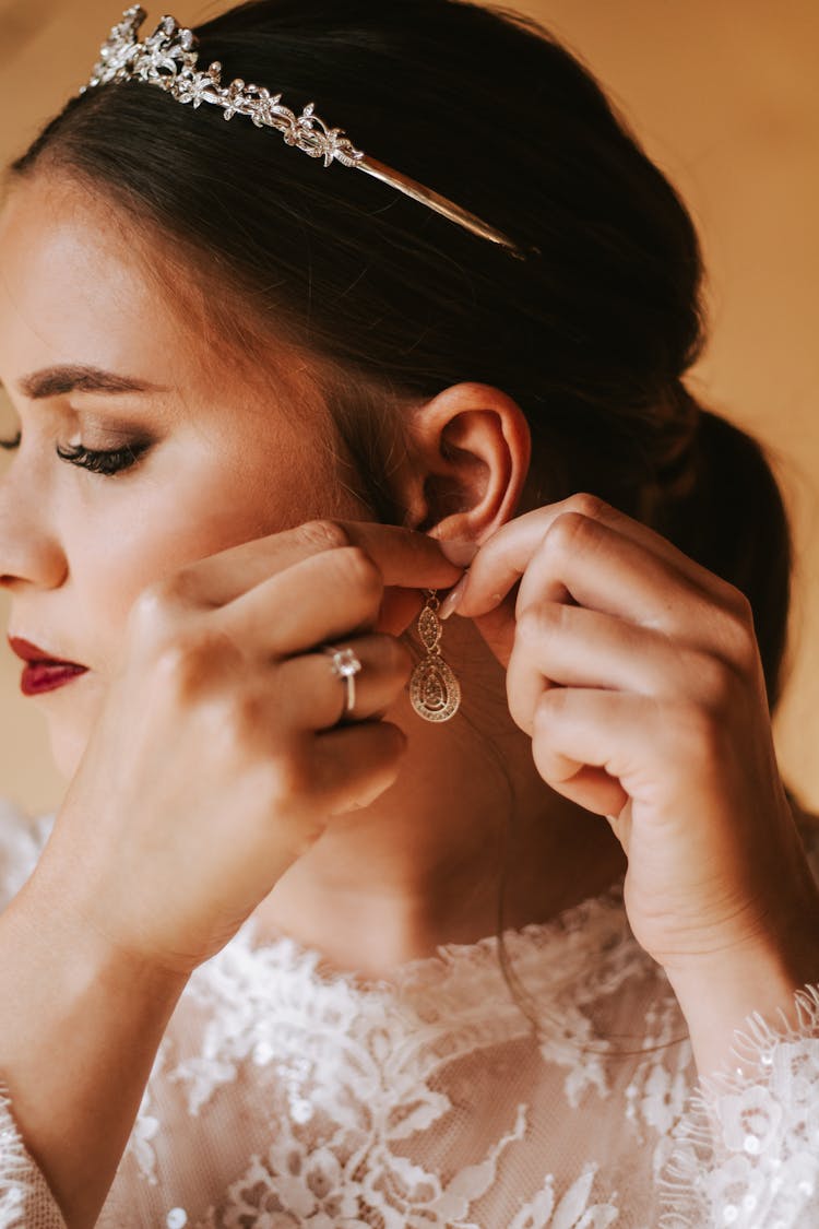 Bride Putting On An Earring