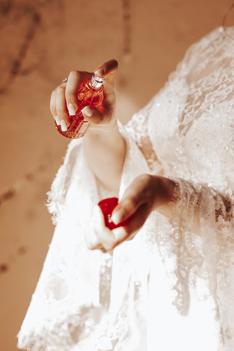 Close Up Of Bride's Hands Spraying Perfume