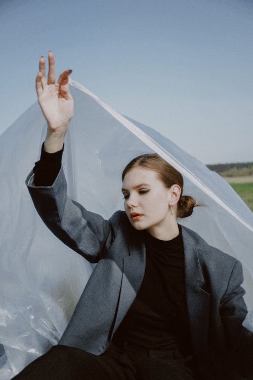 Woman Lifting a Plastic Foil 