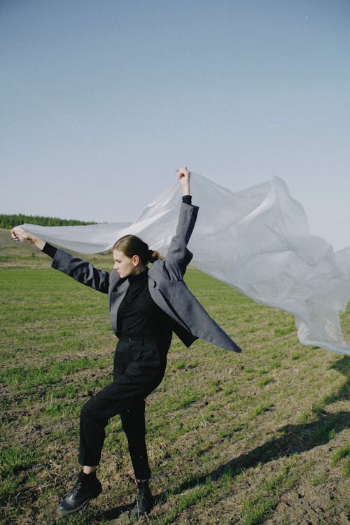 Woman Standing on One Leg Holding Plastic