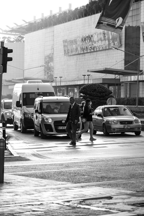 Grayscale Photo of People Walking on Pedestrian Lane