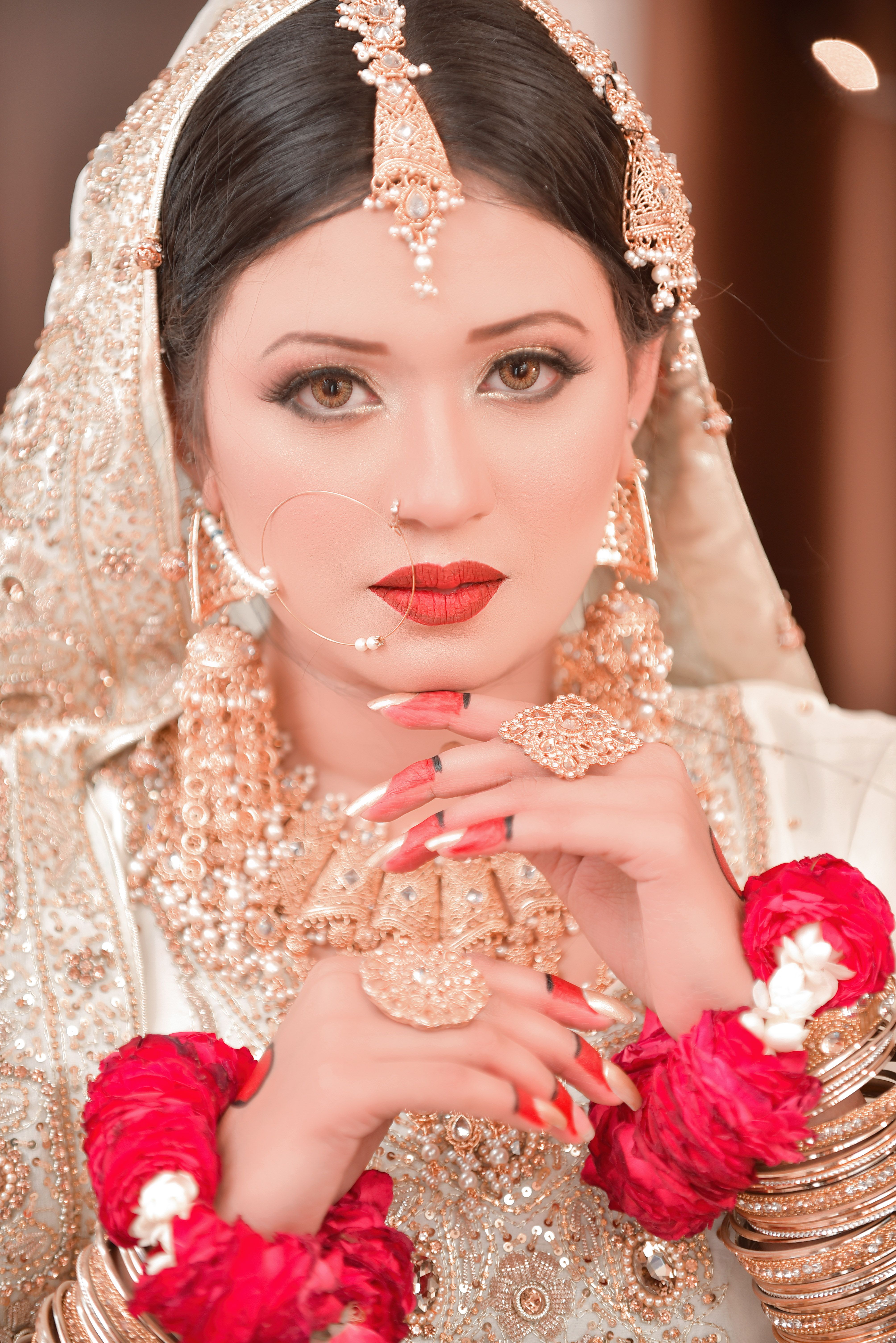 Stunning bride in intricate traditional attire and jewelry, exuding grace.