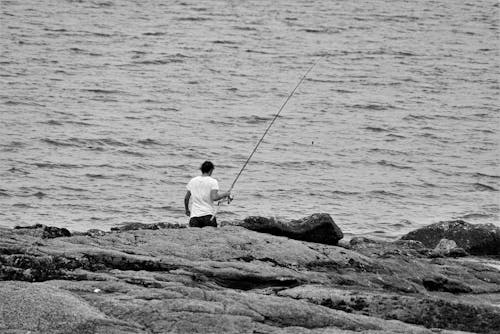 Free Black and White Photo of a Man Fishing Stock Photo