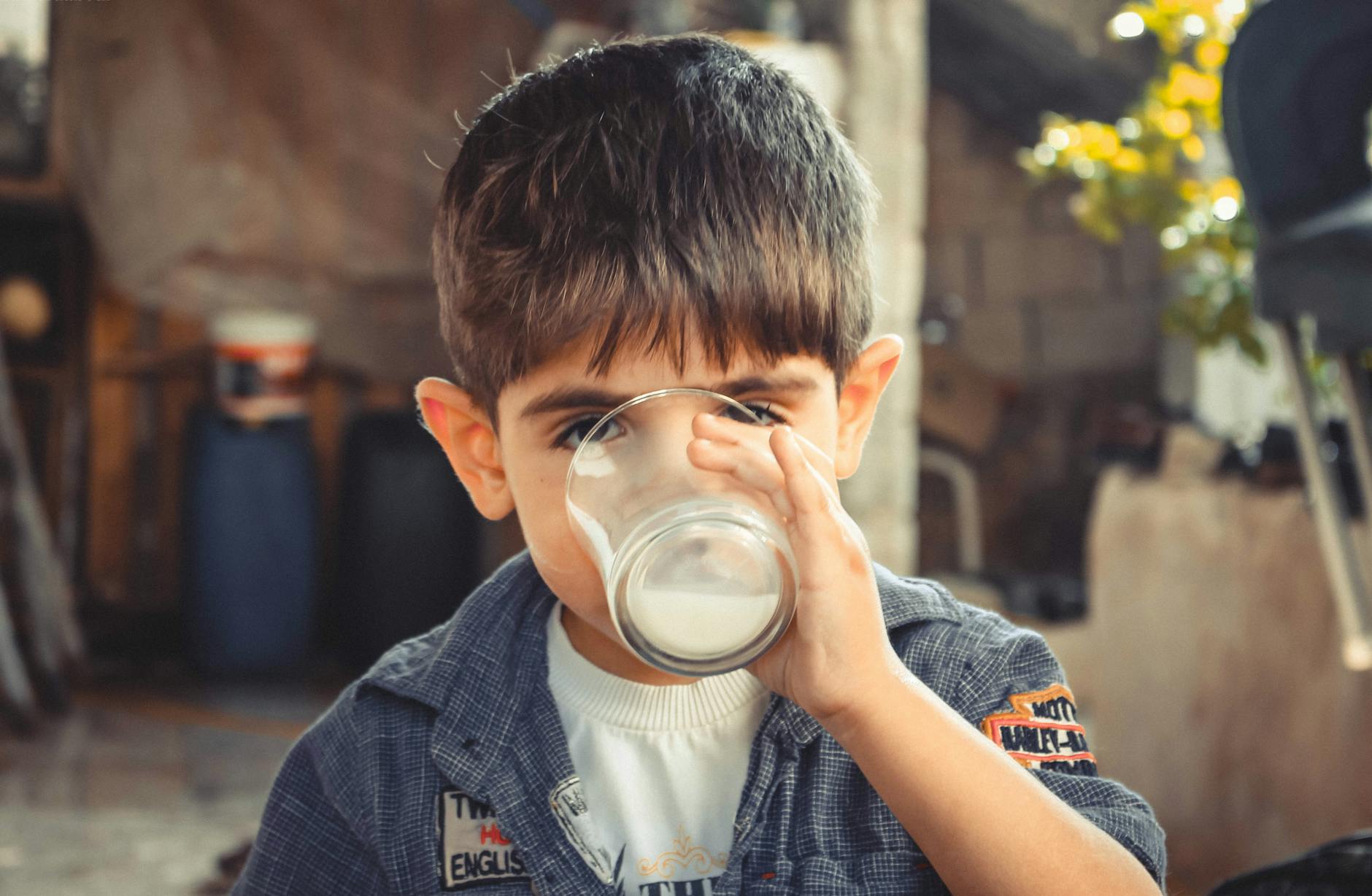 child drinking a glass of milk