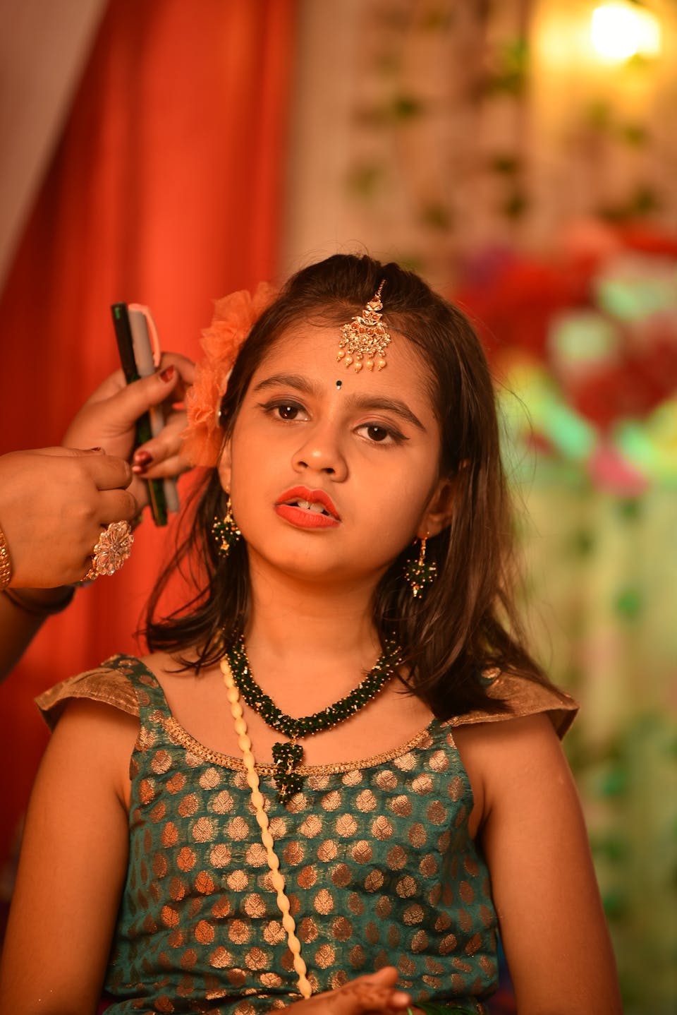 Indoor portrait of a child in a pastel organza lehenga with statement jewelry