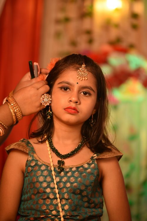 Free Young Indian girl in traditional attire getting ready for a cultural celebration. Stock Photo