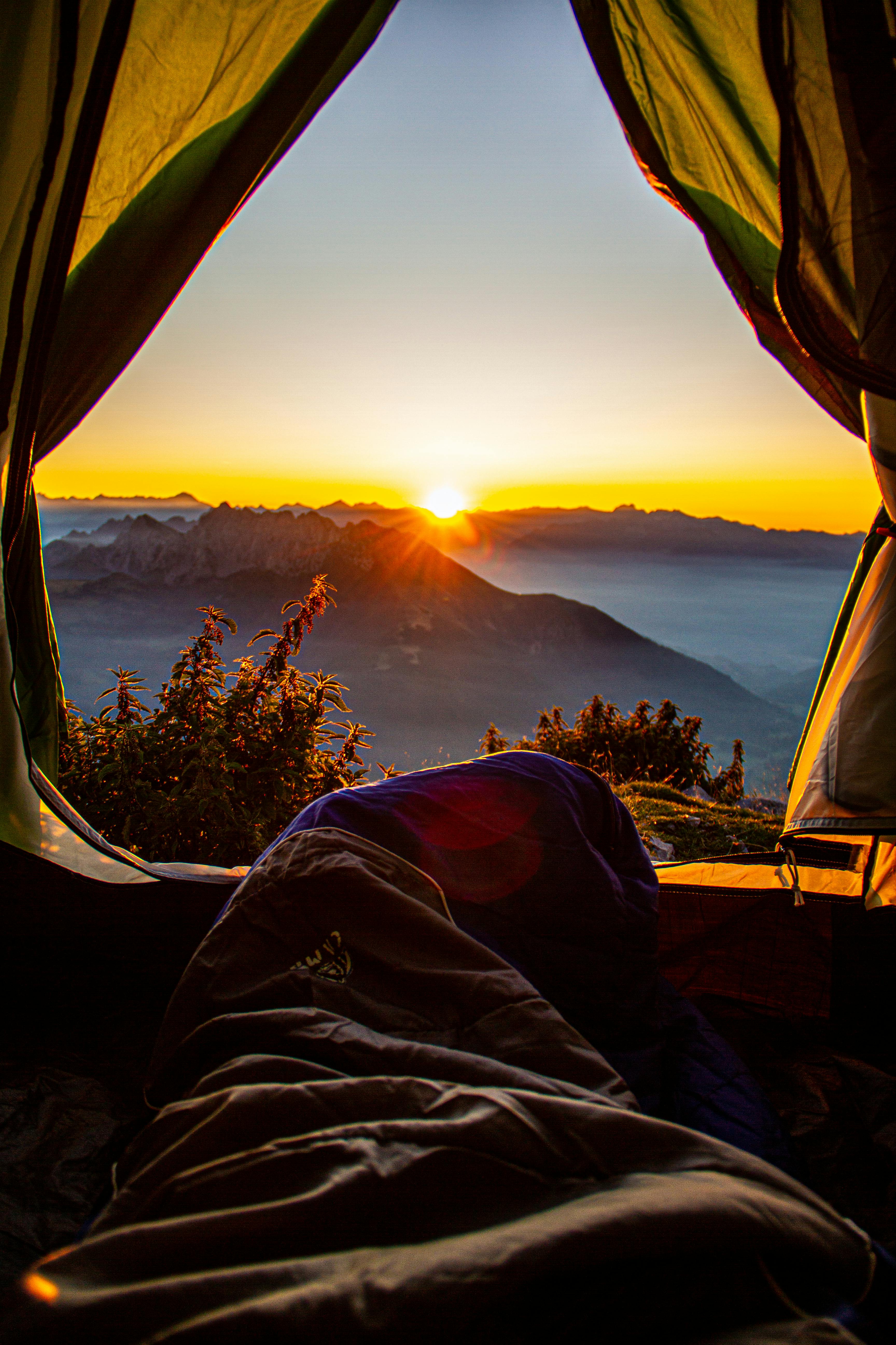 Watching sunrise from a tent in the mountains